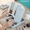 A person's hands are shown organizing makeup in a white organizer with a tri-fold LED mirror. Anteprima dell’immagine prodotto