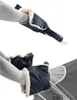 Two images showing a person's arms wearing black hand warmers with cream-colored lining, attached to a stroller handle. Náhľad obrázku produktu