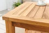 A close-up view of a wooden side table with a slatted top. Produktbild-Vorschau