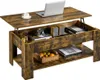 A lift-top coffee table with storage, a laptop, and decorative items.