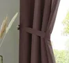 A close-up of a brown curtain tied back with a fabric tie. Produktbild-Vorschau