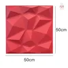 A red 3D wall panel with geometric facets, shown flat against a white background with size indicators. Produktbild-Vorschau