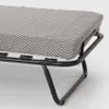A close-up view of a folding bed with a chevron-patterned mattress. Produktbild-Vorschau