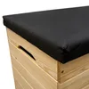 A close-up view of the corner of a wooden storage box with a black cushion on top. Anteprima dell’immagine prodotto