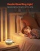 A child sleeping in bed next to a white noise machine with a gentle glow ring light. Produktbild-Vorschau