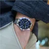 A close-up shot of a man's wrist wearing a Tommy Hilfiger watch, with his hand in his pocket. Anteprima dell’immagine prodotto