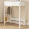 A white desk with a backpack and purse hanging on it, set against a light beige wall and wooden floor. Náhľad obrázku produktu