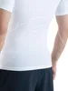 Close-up of a person wearing a white compression shirt and dark shorts. Produktbild-Vorschau