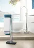 A modern bathroom with a freestanding bathtub and a towel rack with towels, overlooking a scenic view. Produktbild-Vorschau