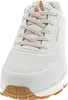 A close-up, front-facing view of a white Skechers sneaker with tan laces and a brown sole. Náhled obrázku produktu