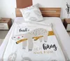 A bed with a sloth-themed duvet cover and pillow. Produktbild-Vorschau