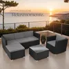 A rattan lounge set is arranged on a patio overlooking the ocean at sunset. Náhled obrázku produktu