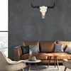 A living room scene with a brown leather sofa and a decorative bull skull mounted on a dark gray wall. Podgląd zdjęcia produktu