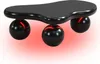 A black, cloud-shaped coffee table with three spherical black legs, illuminated by red light from underneath. Voir les images du produit