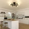 A modern kitchen with a central island and bar stools, featuring a sputnik-style ceiling light. Náhled obrázku produktu