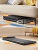 A foldable walking pad shown in two configurations: folded under a sofa and unfolded on a floor. Produktbild-Vorschau