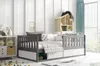 A child's bedroom with a daybed, storage shelves, and decorative items.
