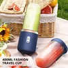 A picnic setting with two portable blenders, fruit, and sunflowers. Podgląd zdjęcia produktu