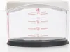 A close-up shot of a clear measuring cup with red markings for volume measurements. Produktbild-Vorschau