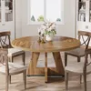 A round wooden dining table with chairs in a well-lit room with a window and cabinets. Anteprima dell’immagine prodotto
