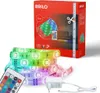 A product shot of an LED strip light kit, including the packaging, the LED strip itself, a remote control, and a power adapter, all presented on a white background. Produktbild-Vorschau