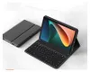 A black tablet with a keyboard case attached, shown on a marble-like surface. Náhled obrázku produktu