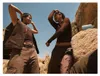 Two people dancing in a desert landscape with rocks. Anteprima dell’immagine prodotto