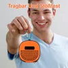 A man is holding an orange portable speaker with a carabiner clip attached. Produktbild-Vorschau