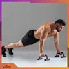 A man is performing push-ups using fitness equipment. Podgląd zdjęcia produktu