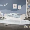 A child's bed in a nursery setting with decorative elements. Produktbild-Vorschau