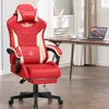 A red gaming chair is shown in a room with a desk and laptop. Náhled obrázku produktu
