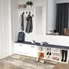 A hallway with a shoe bench, coat rack, and a mirror. Voir les images du produit