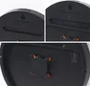 Collage of close-up shots of the back of a digital clock, showing mounting holes, battery compartment, and a stand. Produktbild-Vorschau