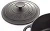 A close-up of a cast iron pot lid with the brand name embossed on it. Produktbild-Vorschau