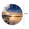 A round wall clock with a sunset landscape image and a measurement indicator. Voir les images du produit