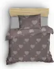 A top-down view of a bed with a duvet cover and pillow featuring a heart pattern.