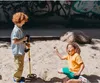 Two children are playing in a sandbox, one with a metal detector. Náhľad obrázku produktu