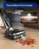 A wet/dry vacuum cleaner is shown cleaning a spill on a wooden floor, with a close-up inset showing a steam feature. Náhled obrázku produktu