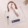 A transparent tote bag filled with personal items, floating against a soft pink background. Anteprima dell’immagine prodotto