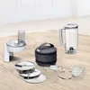 A collection of kitchen appliance attachments and accessories laid out on a wooden surface. Produktbild-Vorschau