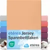 A stack of folded fitted sheets in various colors, with the main product in a peach color prominently displayed in the foreground. Anteprima dell’immagine prodotto