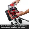Close-up of a person's hands inserting batteries into a red and black garden tiller. Produktbild-Vorschau
