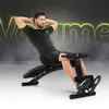 A man is performing a sit-up exercise on a black multi-functional training bench. The background is dark gray with a bright yellow neon outline of the word 'Volume'. Náhľad obrázku produktu