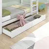 A close-up view of the bottom of a white bunk bed, showing two open drawers with storage items inside. Náhled obrázku produktu