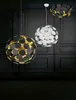 Three modern pendant lights are displayed against a dark, paneled wall. Podgląd zdjęcia produktu