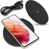 A smartphone is placed on a wireless charging pad, with a USB cable in the background. Produktbild-Vorschau