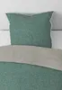 A close-up view of a pillow and bedding. Produktbild-Vorschau