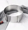 A stainless steel adjustable cake ring on a marble surface with a gray cloth and two cherries. Podgląd zdjęcia produktu