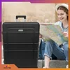A young woman is sitting on steps, looking at a map, with a black suitcase next to her. Anteprima dell’immagine prodotto