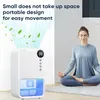 A woman meditates next to a white air purifier that is emitting blue air and green leaves. Produktbild-Vorschau